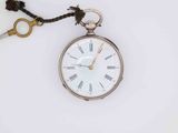 a silver pocket watch with a key attached to it