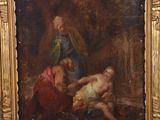 painting on easel of a painting of a man and a woman in a wooded setting