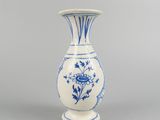 blue and white vase with a flower design on the bottom