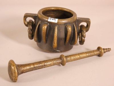 a small vase with a wooden handle next to it