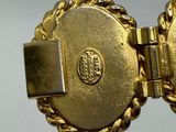a close up of a gold bracelet with a clasp on it