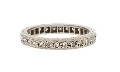 a white gold ring with diamonds on a white background