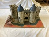 a castle made out of cement sitting on a table