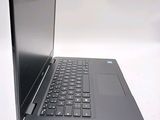 a laptop computer sitting on top of a white table