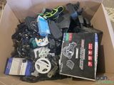 a cardboard box full of electronic gadgets and other electronics