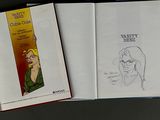 four books that are lined up on a table