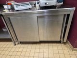 a stainless steel counter with a machine on top of it