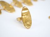 an image of a close up of a gold ring on a white surface