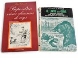 two books are sitting on a white surface one is a bear and the other is a bear