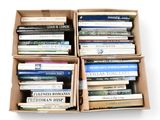 boxes of books are stacked on top of each other on a white surface