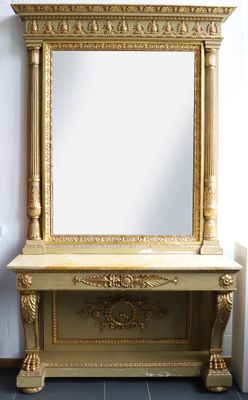 an image of a gold mirror sitting on top of a wooden table