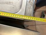 someone is measuring the width of a dishwasher with a tape