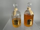 two bottles of liquor sitting on top of a glass table