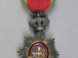 an image of a medal with a red ribbon and a star on it