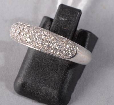a close up of a diamond ring on a black glove