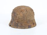 an old helmet on a white surface with a white background