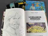 a lot of books on the table with a drawing of a man