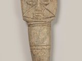 a close up of a stone object with a face on it
