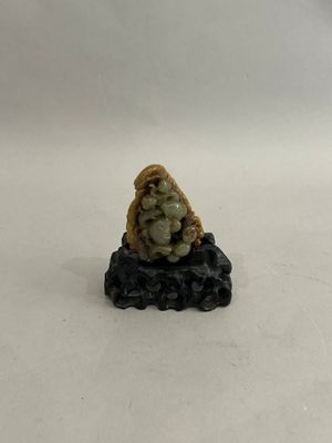 a small figurine of a woman sitting on a rock