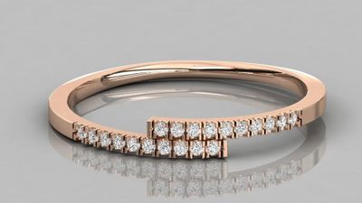 a close up of a diamond ring on a reflective surface