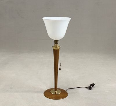 lamp with a white glass shade on a wooden base and a black cord