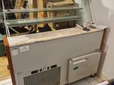 a counter with a glass case on top of it