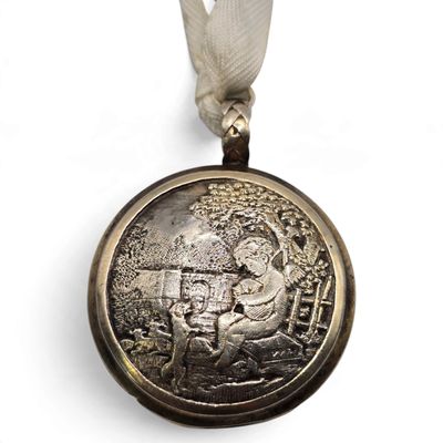 a silver medal with a silver ribbon around it