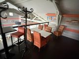 a table and chairs in a room with a view of the city