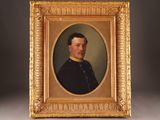 an old picture of a man in a military uniform in a gold frame