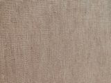 a close up of a speaker with a brown cover on a table