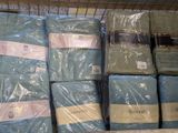 many blankets and blankets stacked on a shelf in a store