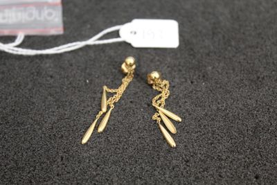 a close up of a pair of earrings on a table