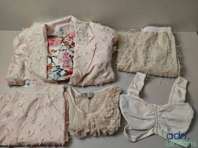 several pieces of clothing sitting on top of a table next to each other