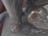 a statue of a dog that is sitting on top of a table
