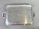 rectangular silver plate with handles and handles on a white surface