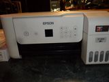 a printer that is sitting on a counter next to a box