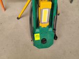 an image of a green machine sitting on top of a cement floor