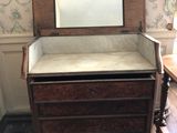 a dresser with a mirror on top of it in a room