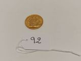 a small gold coin with a price tag on it