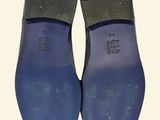 the back of a pair of blue shoes on a white background