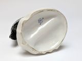 porcelain figurine of a black and white fish on a white background