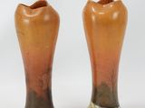 two vases that are sitting on a white surface