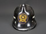 a close up of a fireman ' s helmet on a gray background