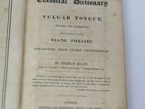 an old book that is open on a table
