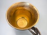 a gold cup that is sitting on a table