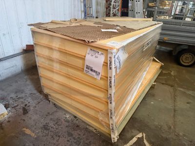 a pile of wood sitting in a warehouse next to a truck