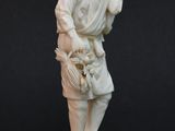statue of a man with a basket of flowers in his hand