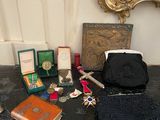 a table with a purse, a purse, a book, and other items on it
