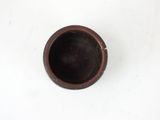 a small brown cup sitting on a white surface