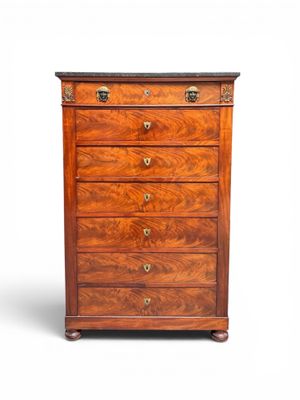 an antique chest of drawers with a wooden top and brass handles
